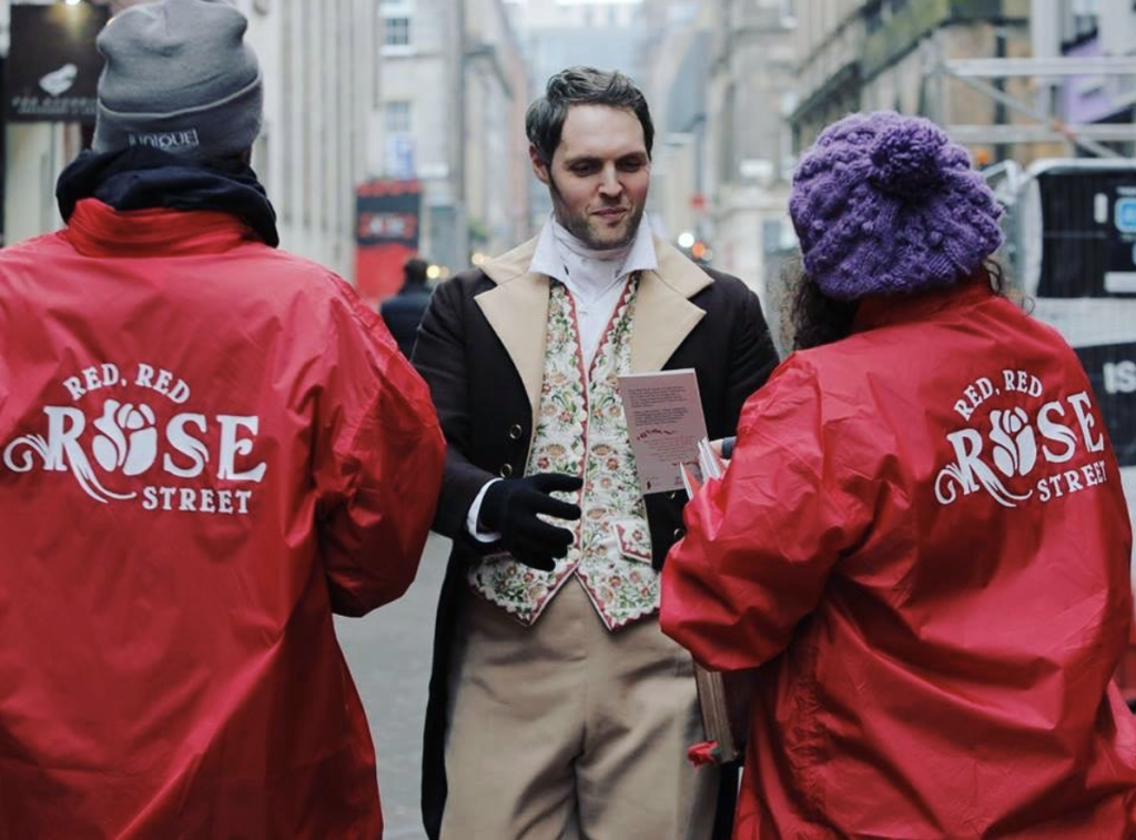 Man dressed as Robert Burns standing on Rose Street